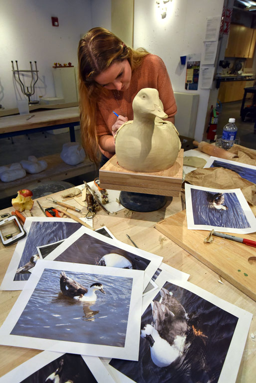 Student working on art sculpture