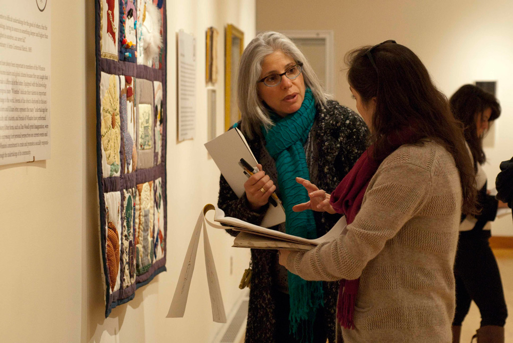 Professor Claudia Fieo working with one of her printmaking students in Wheaton's Beard & Weil Galleries