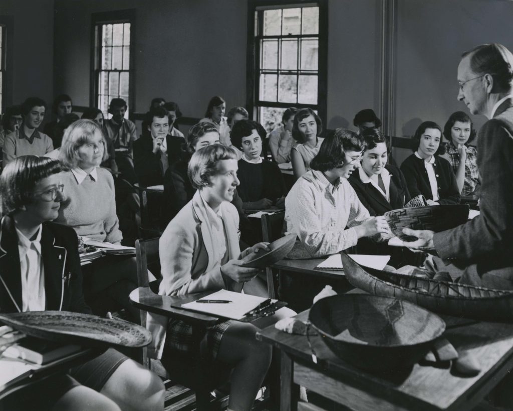 Photograph of Prof. Cressey using the Kilham Basket Collection as part of a lecture on primitive man