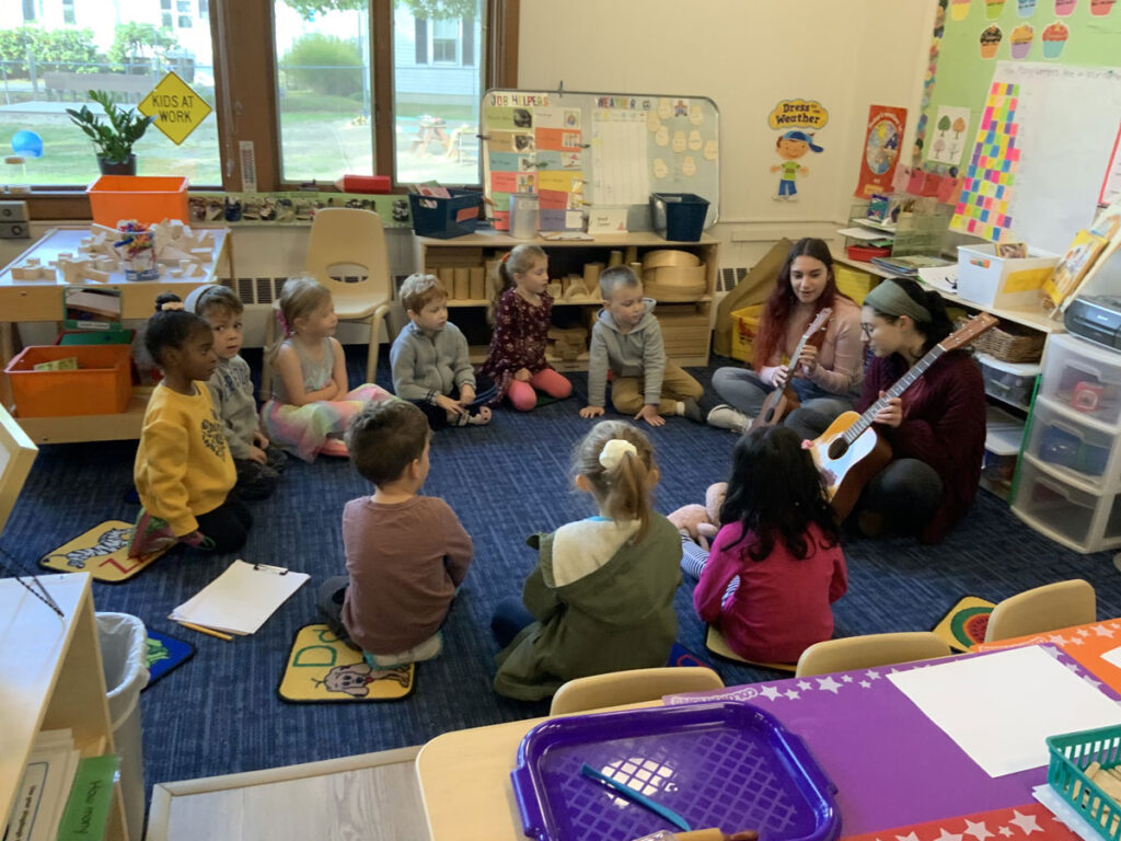 Children enjoying guitar music