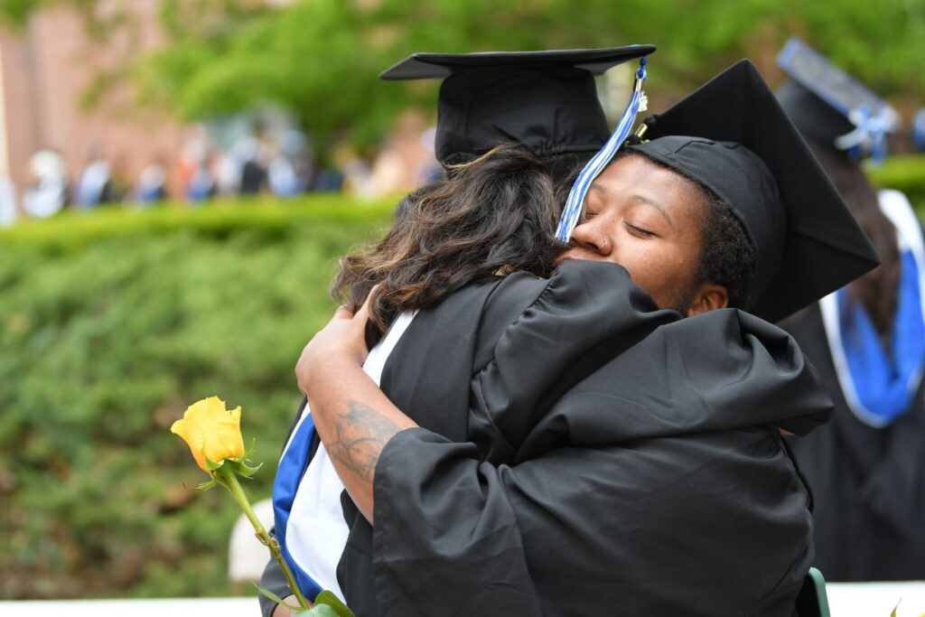 Commencement 2023 - Two graduates hugging