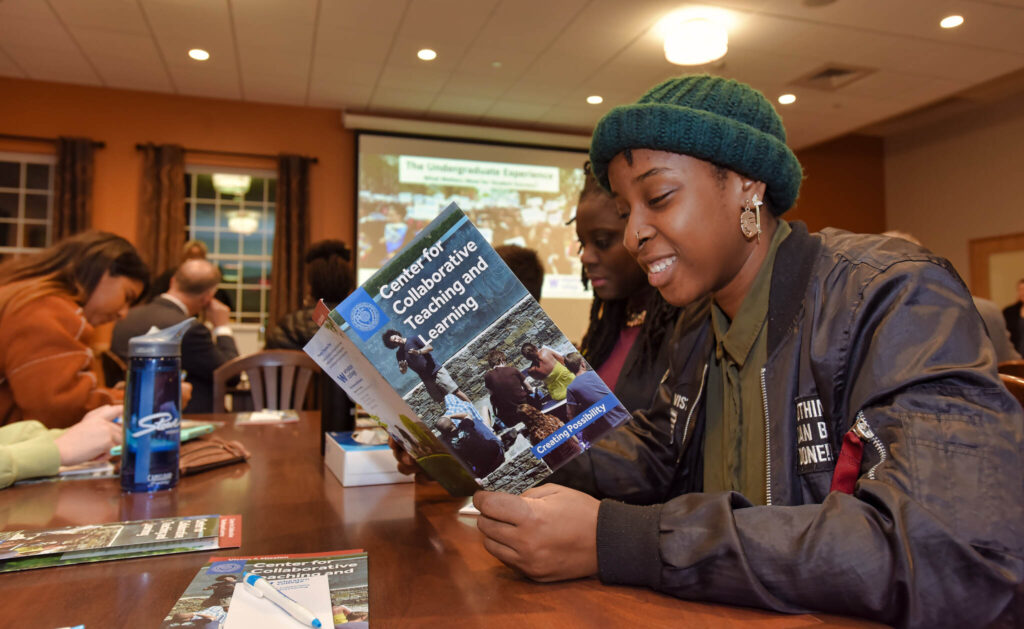 Student reading information about Center for Collaborative Teaching and Learning