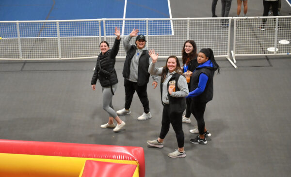 Group of students waving to the camera
