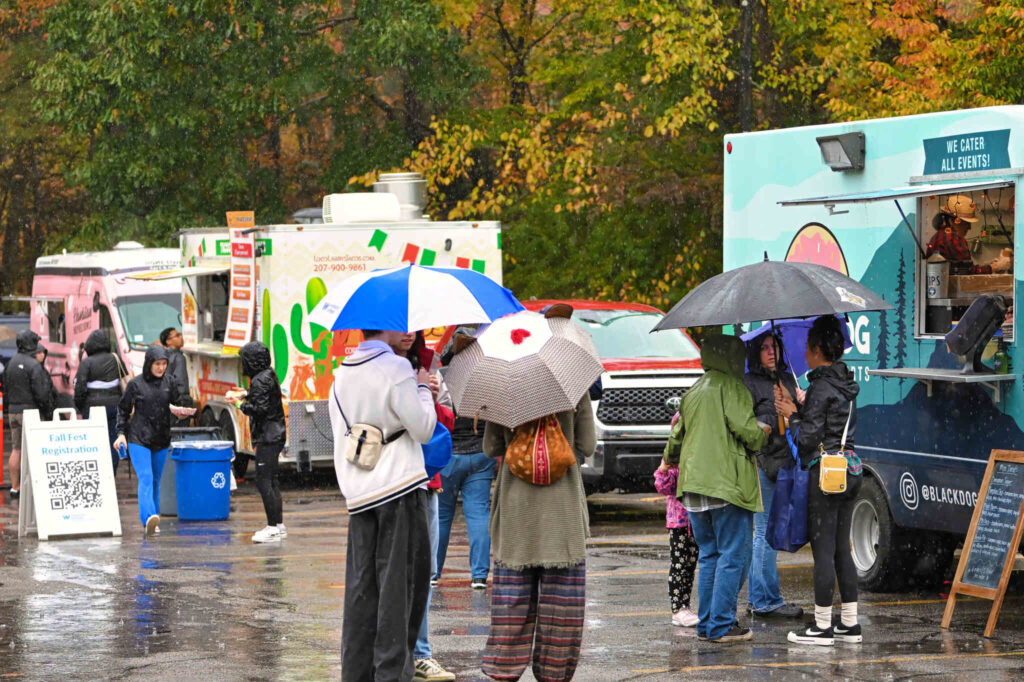 Students standing by food trucks