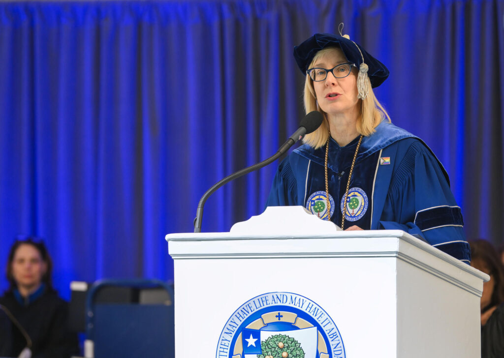President Michaele Whelan speaking behind a podium at the start of the Commencement 2024 ceremony.