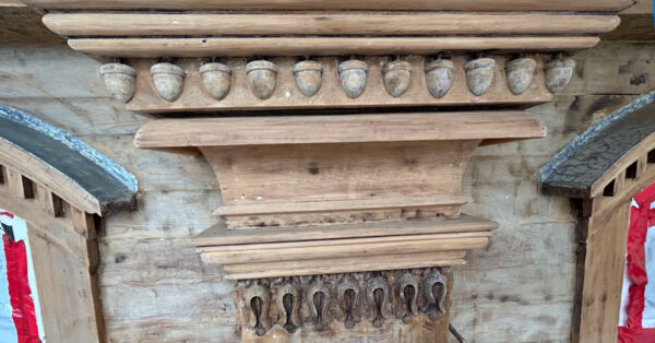 Close-up of paint-stripped pilasters and carved wooden details on the exterior of Mary Lyon Hall.